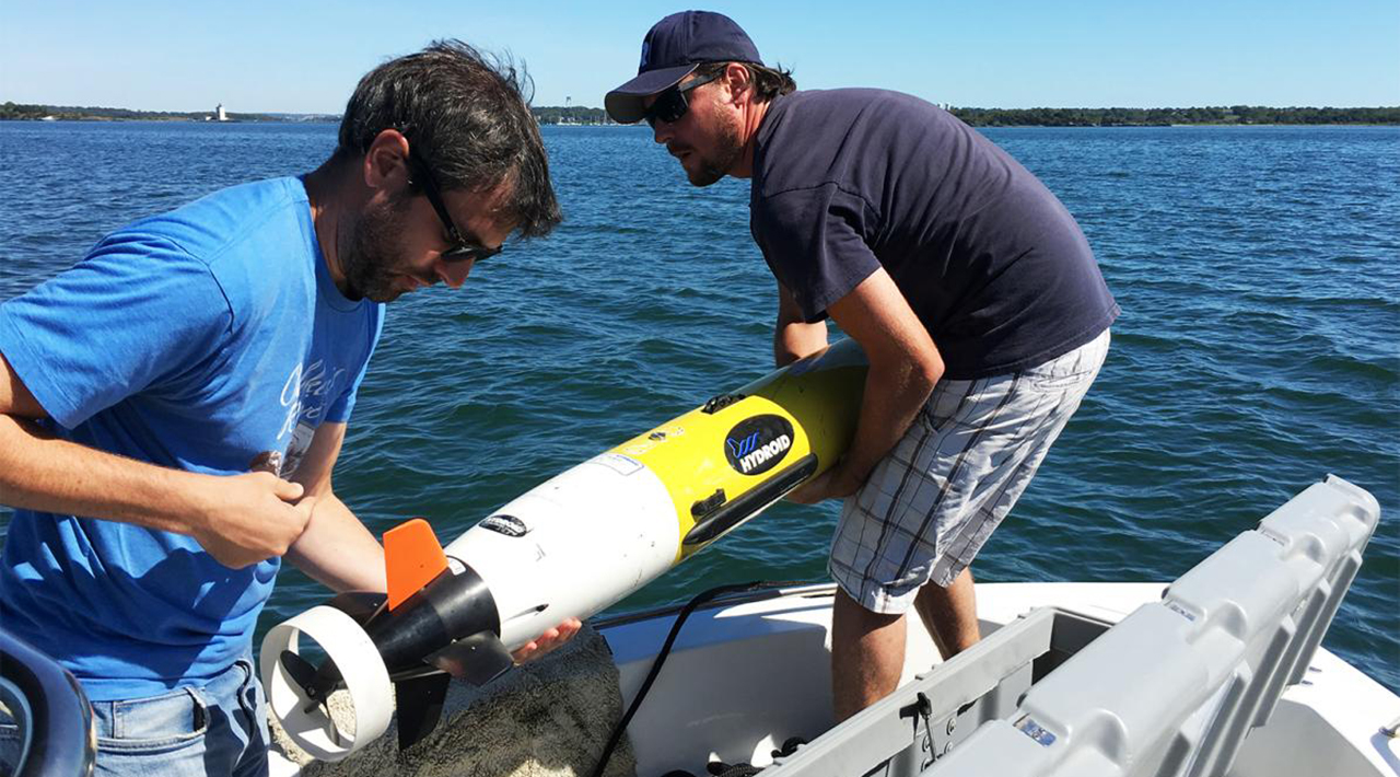 Two scientists preparing an underwater drone