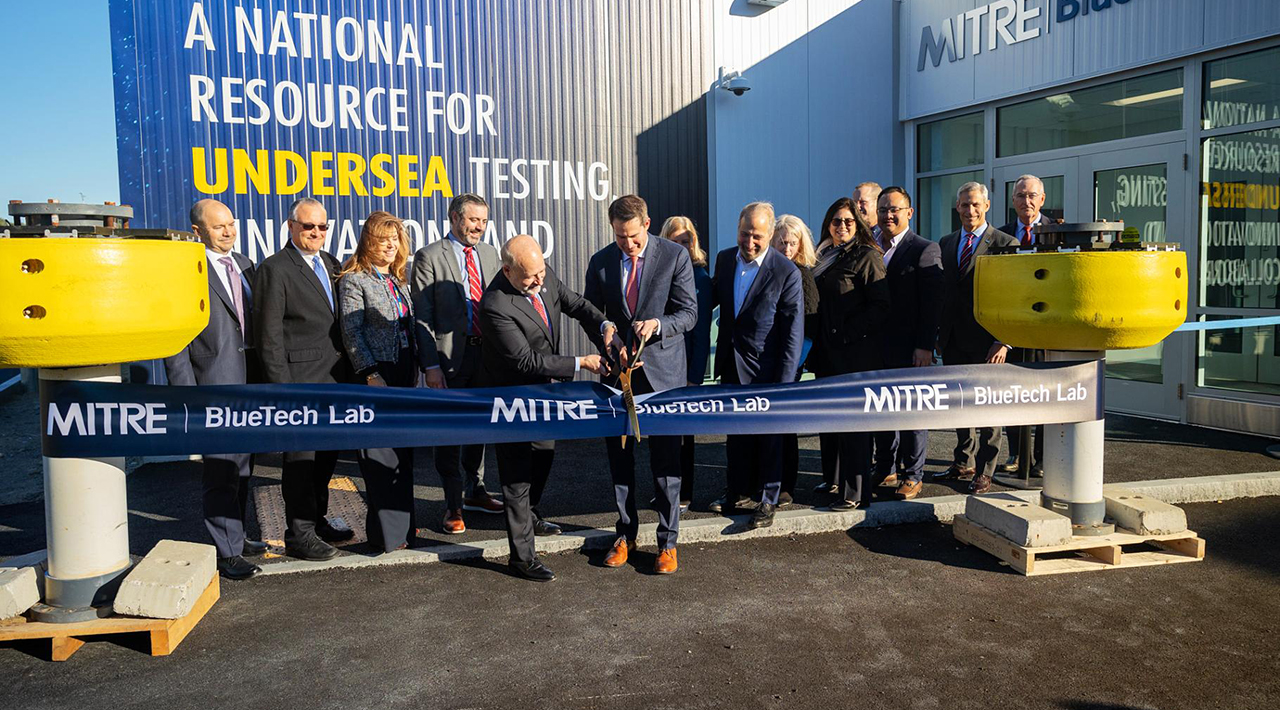 MITRE BlueTech team and MITRE leaders cutting ribbon at BlueTech opening